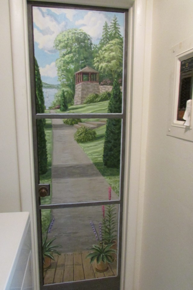 A door to a half bath off of the kitchen