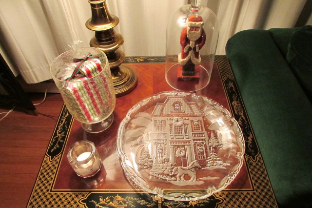 A grouping of glass items on an end table. 