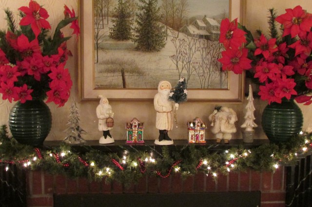 Some Chalk-ware Santas on the fireplace mantel.  