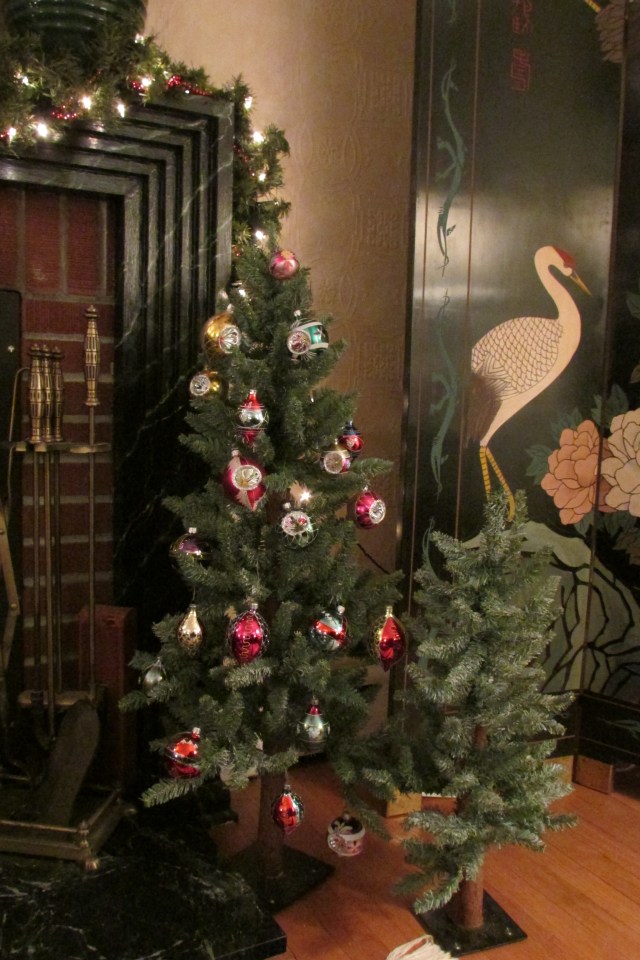 One of the two sets of small trees that flank the fireplace.