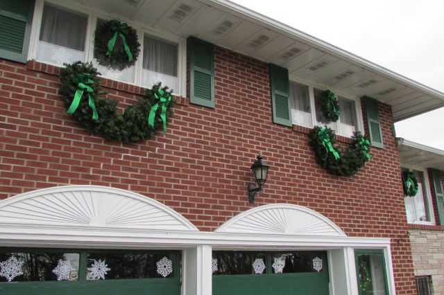  and large artificial evergreen swags and cut paper snowflakes add visual interest to the front facade of my house.